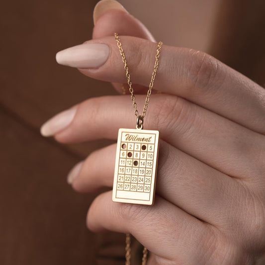 A rectangular calendar pendant necklace, engraved with a custom date and name, crafted from 925 Sterling Silver or 14K Gold Plated. Ideal for anniversaries, weddings, and birthday gifts.