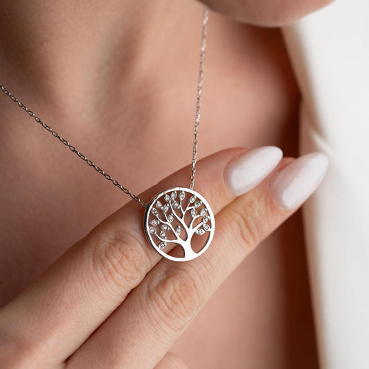 Tree of Life pendant necklace with cubic zirconia stones, available in 925 sterling silver and 14K gold plated options, displayed on a white satin background