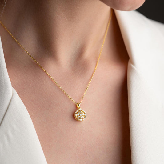 Octagon pendant necklace with cubic zirconia stones, available in 925 sterling silver and 14K gold plated options, displayed on a white satin background