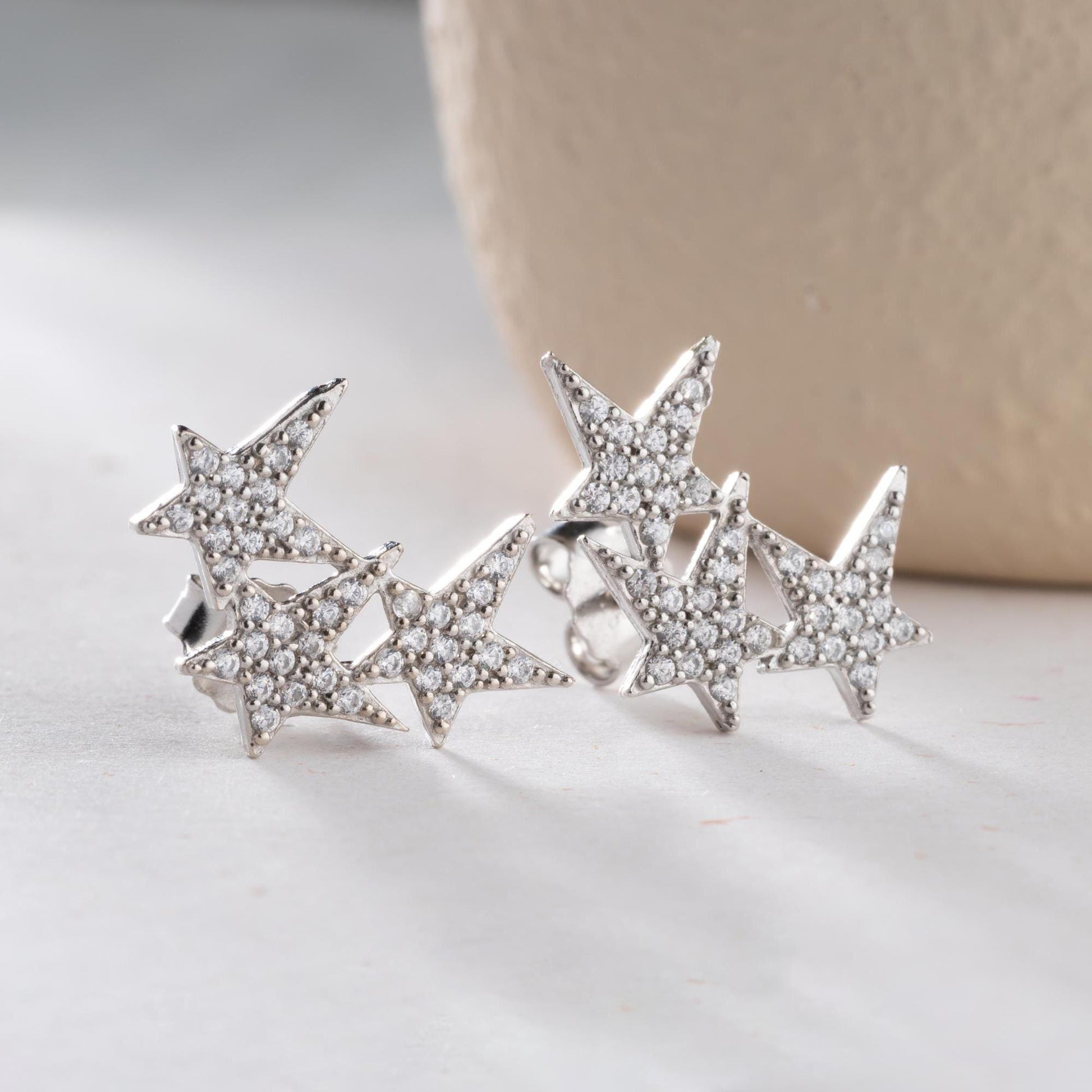 Star cluster earrings in 925 Sterling Silver and 14K Gold Plated options, adorned with cubic zirconia stones for an elegant holiday look.