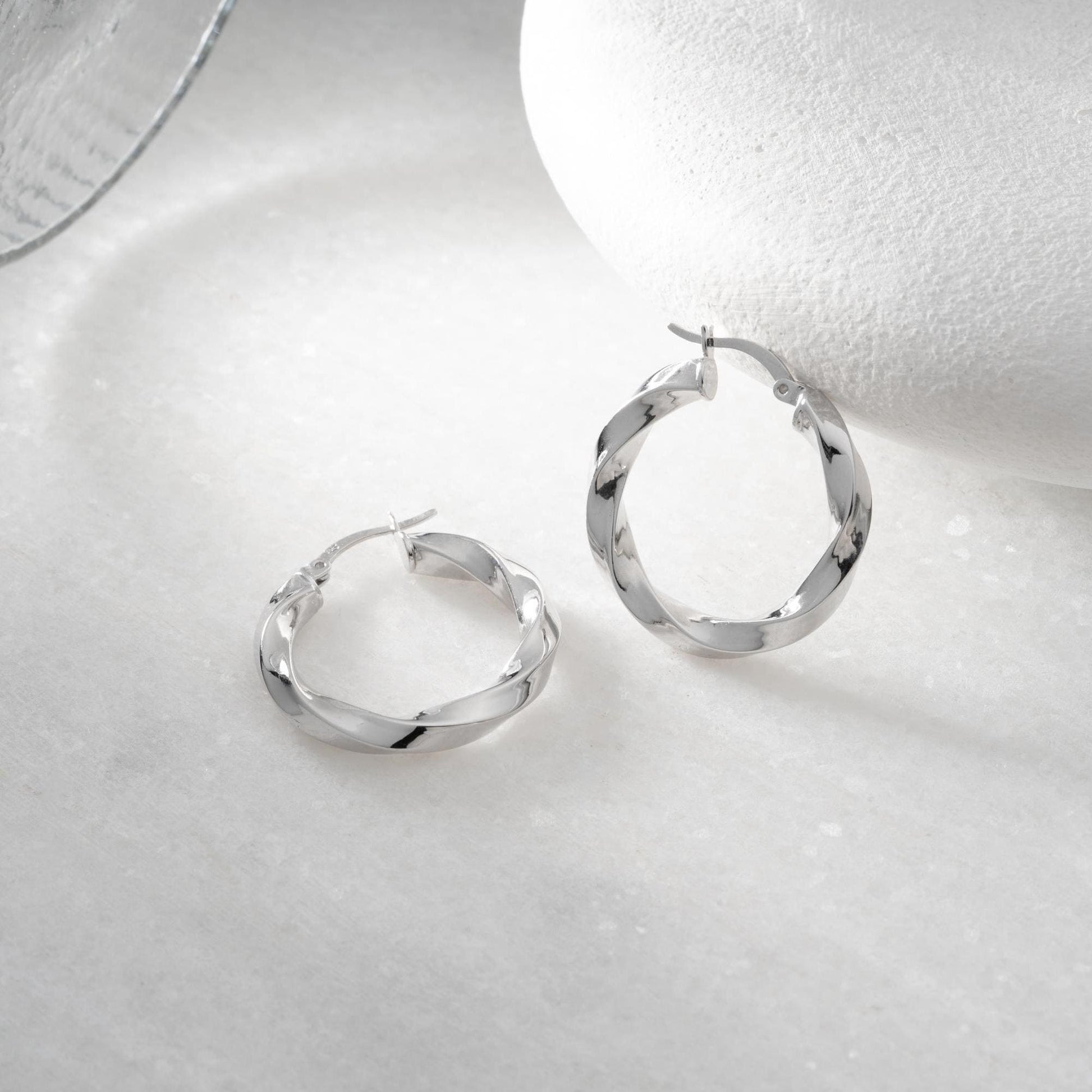 Twisted hoop earrings crafted from 925 sterling silver with a 14K gold-plated option, featuring a lever back closure, perfect for Christmas gifting and everyday wear.