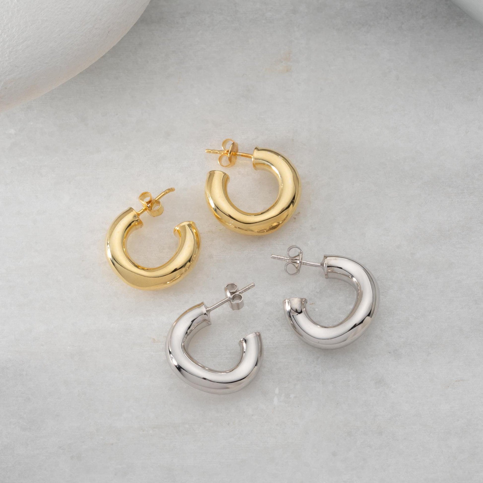 Chunky hoop earrings crafted from 925 sterling silver with a 14K gold-plated option, perfect for a minimalist yet bold look.