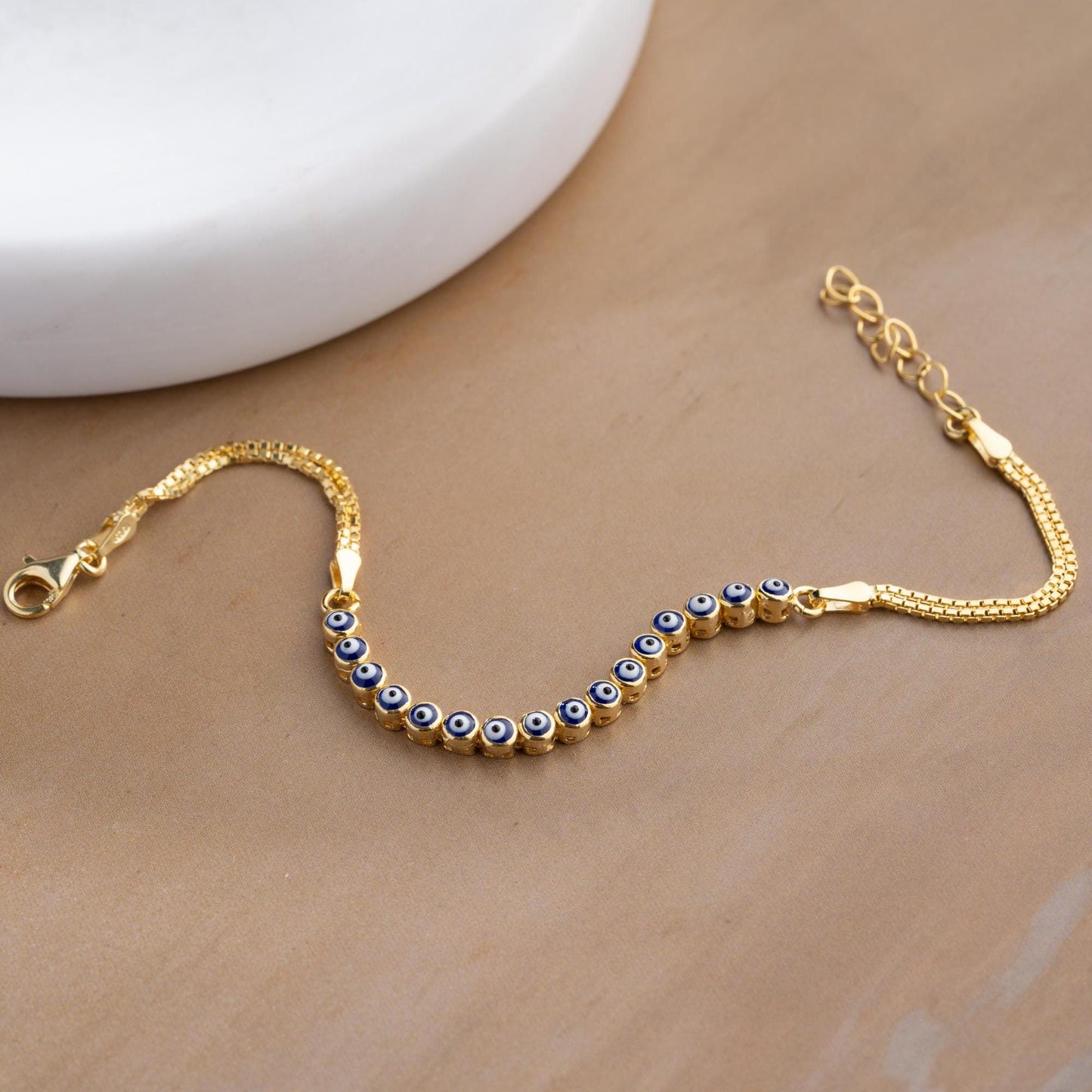 Evil eye bracelet crafted from 925 sterling silver with a 14K gold-plated option, featuring protective and stylish evil eye charms.