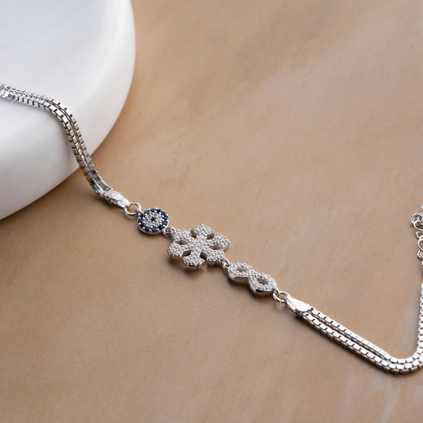 Double chain bracelet with snowflake, infinity, and evil eye charms, crafted in 925 Sterling Silver and 14K Gold Plated, perfect for Christmas or special occasions.