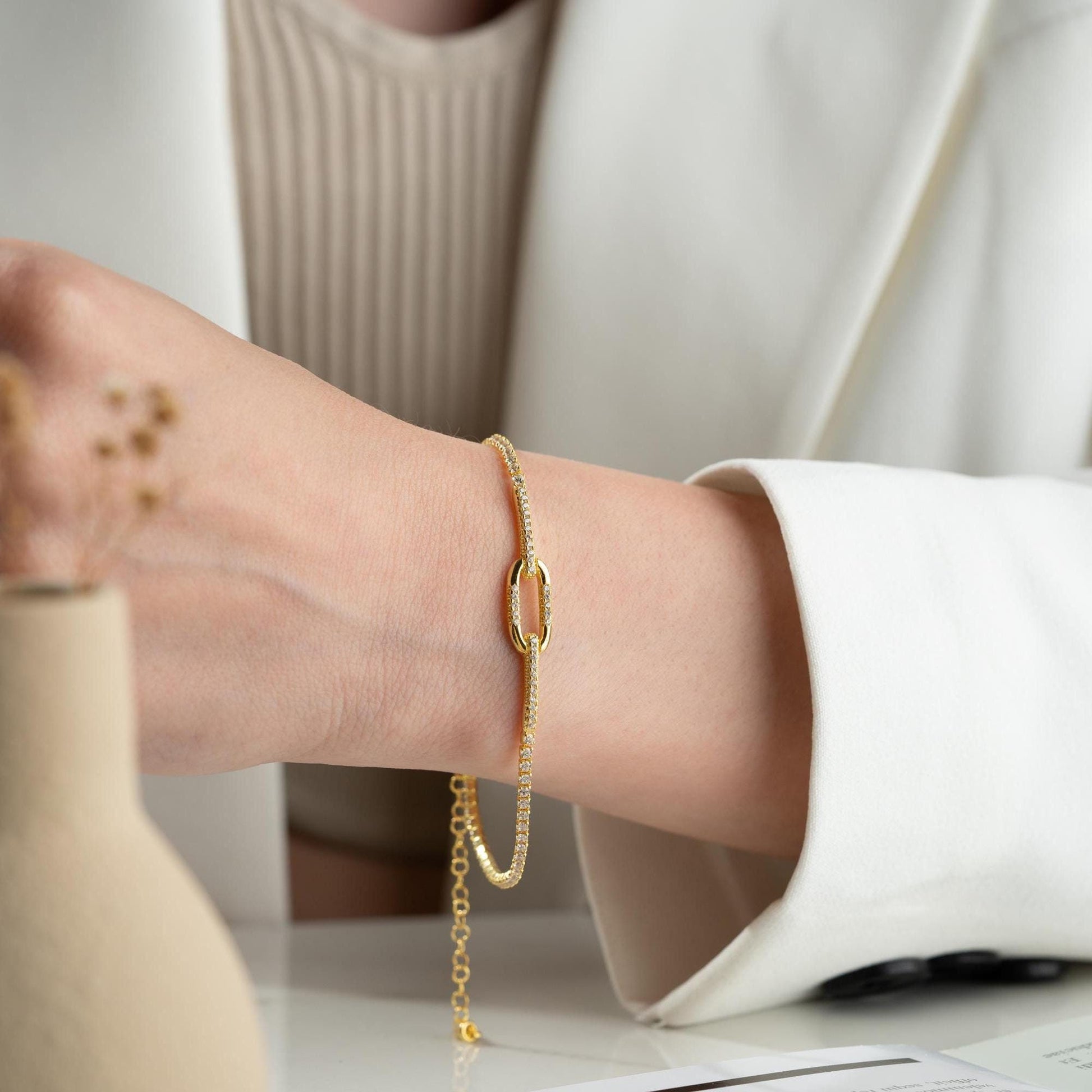 Elegant link chain tennis bracelet with cubic zirconia stones, crafted in 925 Sterling Silver and available in silver and gold finishes, perfect for festive gifting.