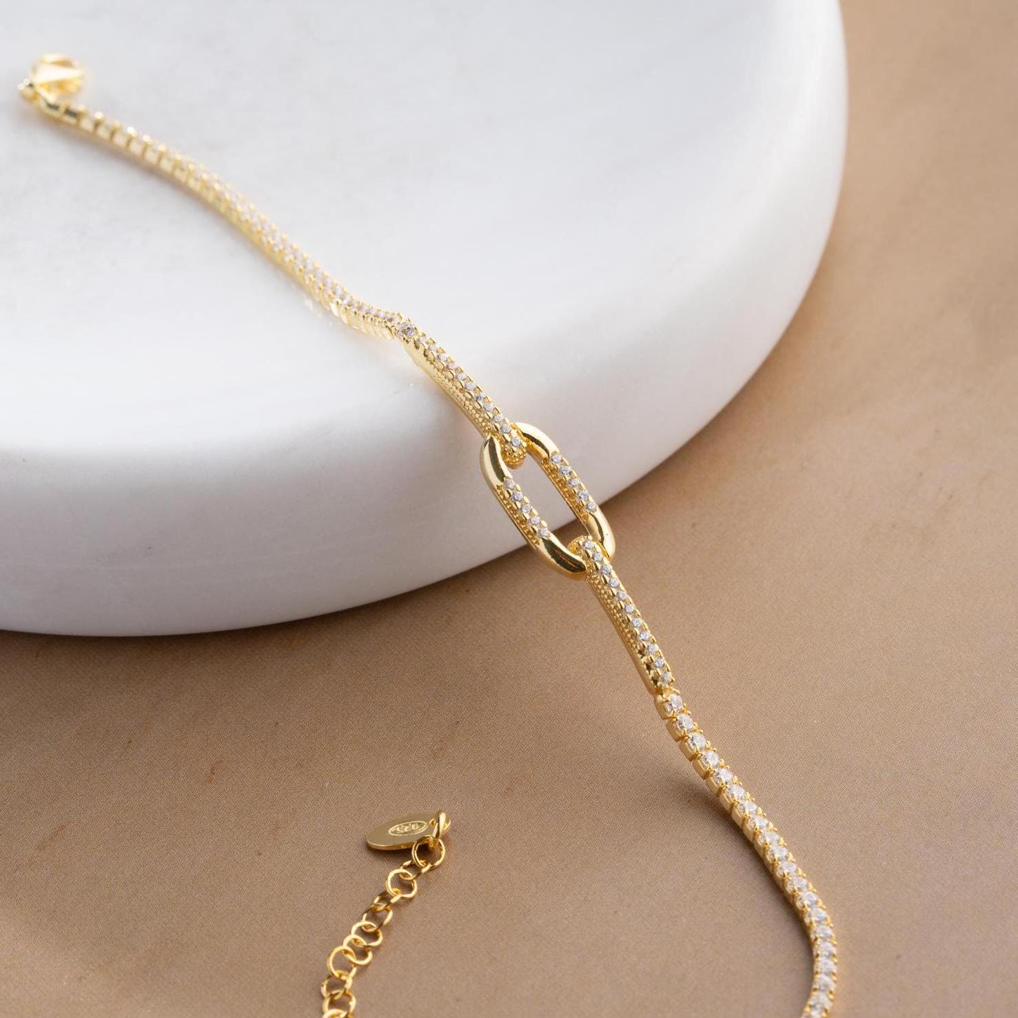 Elegant link chain tennis bracelet with cubic zirconia stones, crafted in 925 Sterling Silver and available in silver and gold finishes, perfect for festive gifting.