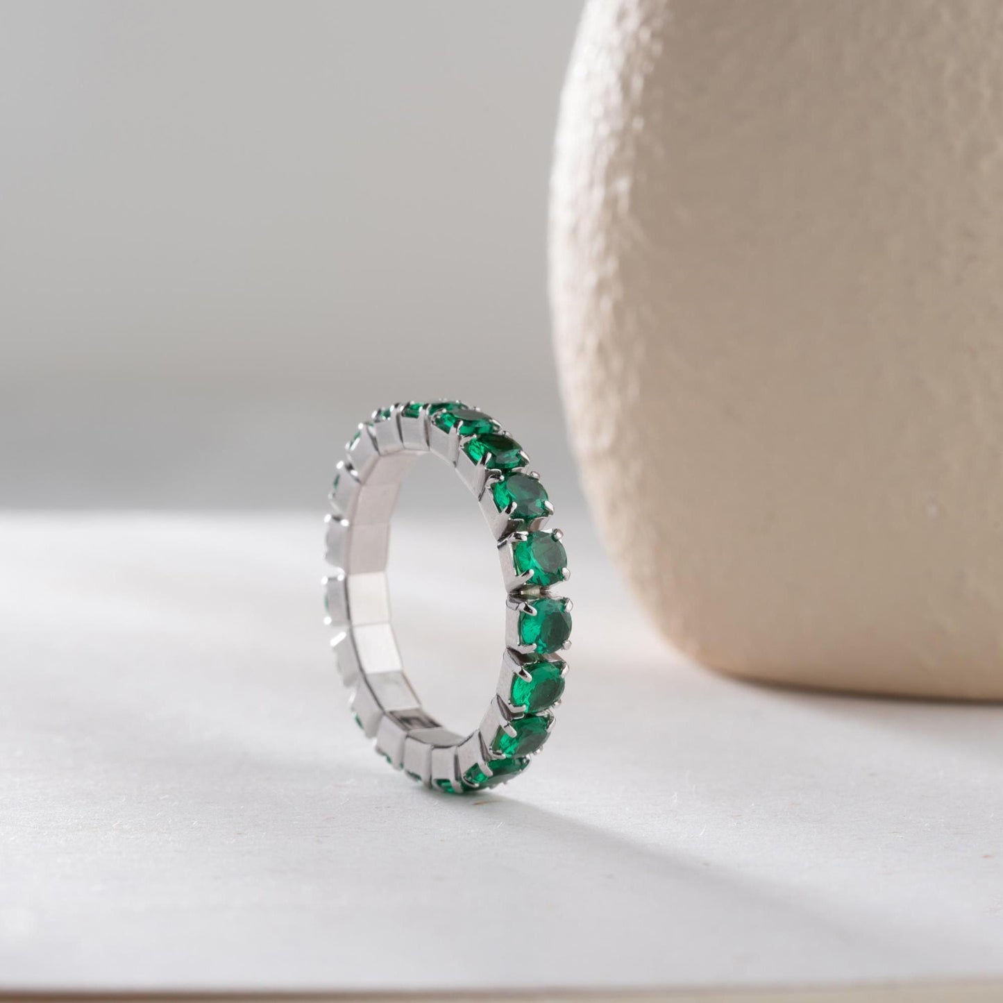 Single vibrant tennis ring crafted in 925 Sterling Silver with colorful cubic zirconia stones, available in rainbow, red, blue, green, black, and pink.