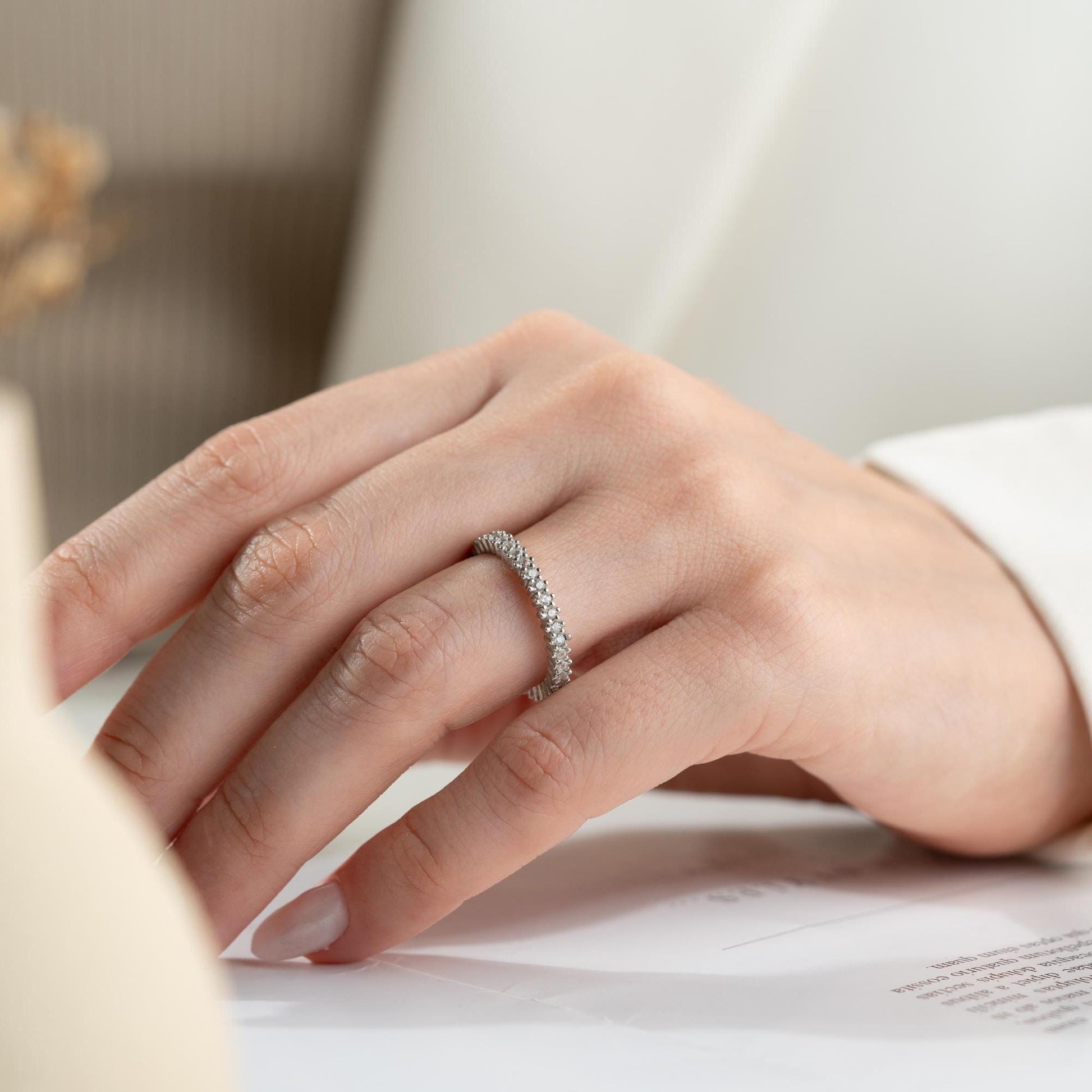 Elegant white zircon tennis ring made from 925 Sterling Silver, with brilliant stones set around the entire band. Adjustable and hypoallergenic.