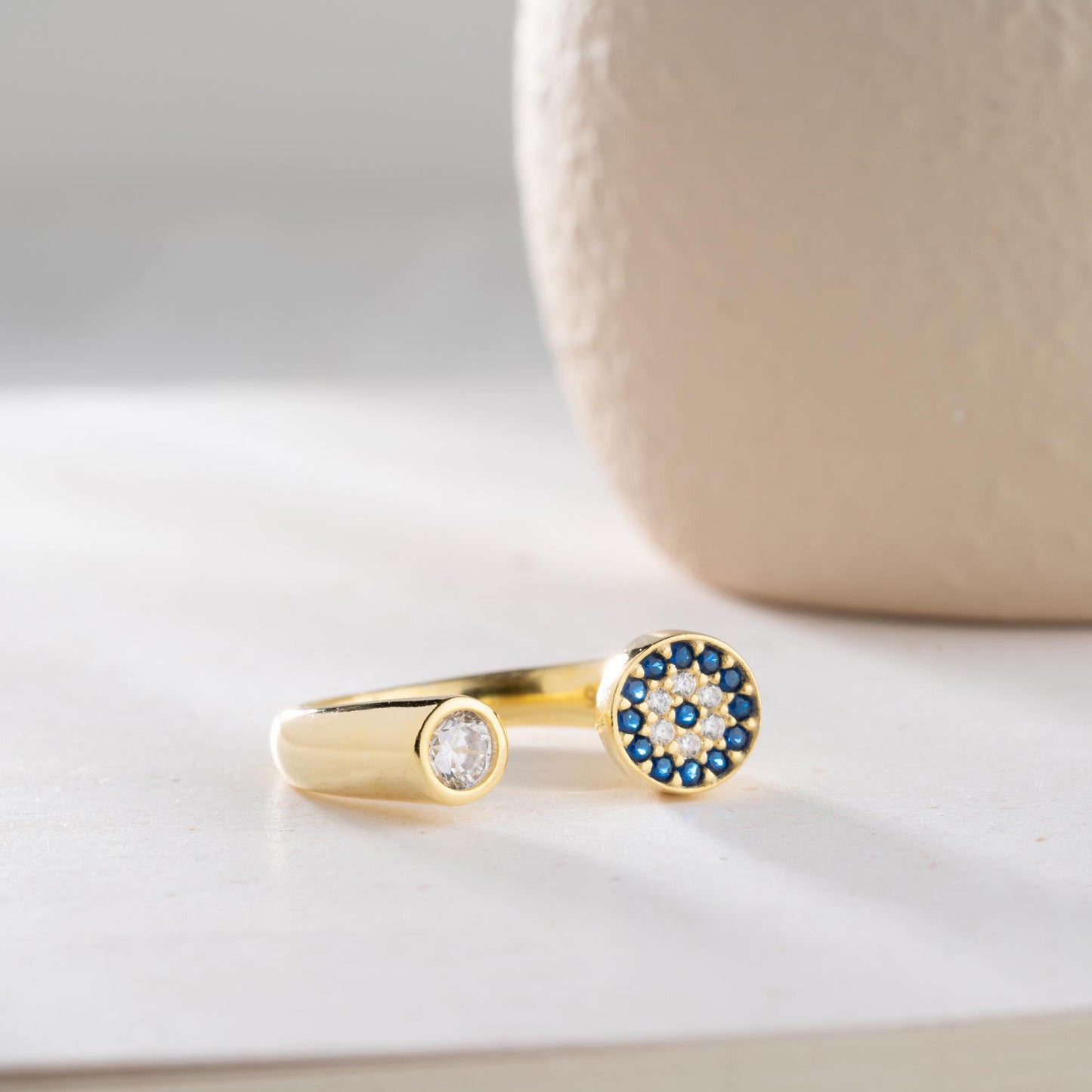 Adjustable open ring featuring a round evil eye charm with cubic zirconia stones, crafted in 925 Sterling Silver and 14K Gold Plated finish.