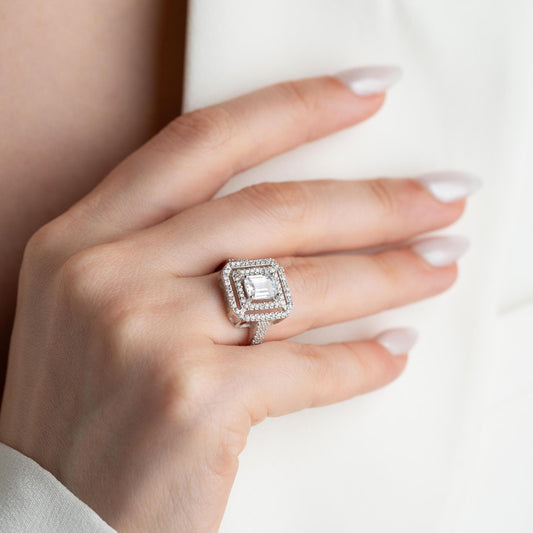 Elegant emerald cut double halo statement ring crafted in 925 sterling silver with cubic zirconia stones, available in silver and gold plated finishes.