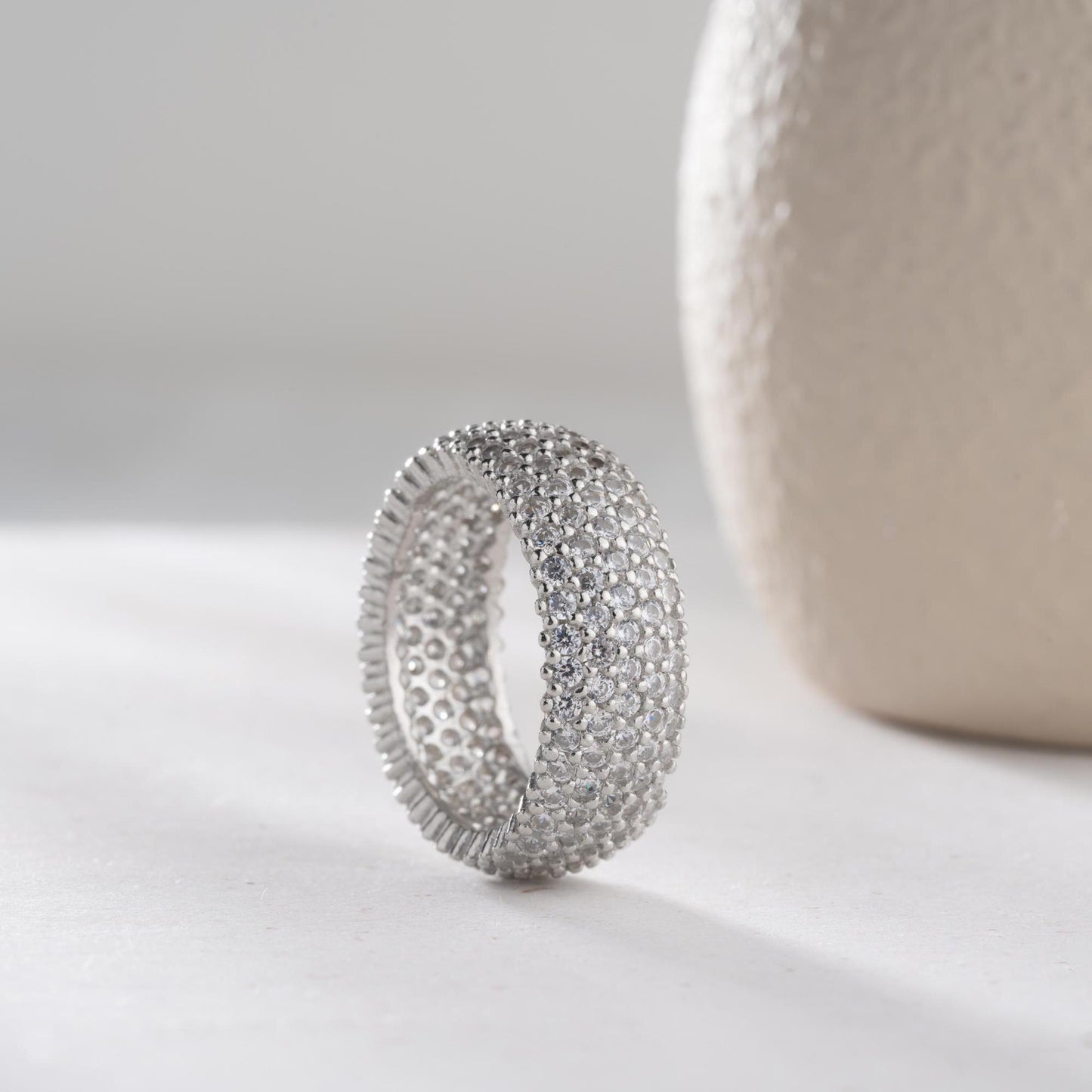Full eternity band ring featuring pave cubic zirconia stones in clear and turquoise options, set in 925 sterling silver. A versatile, stackable piece perfect for gifting or personal wear.