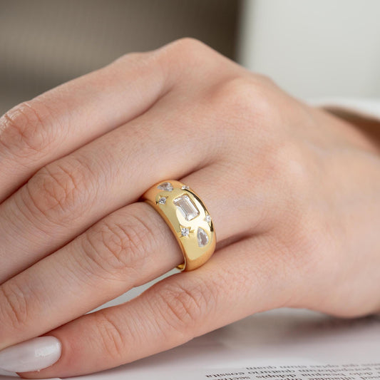 Baguette and teardrop cubic zirconia band ring in 925 sterling silver and 14K gold plating, featuring celestial star motifs. Elegant statement ring for women.