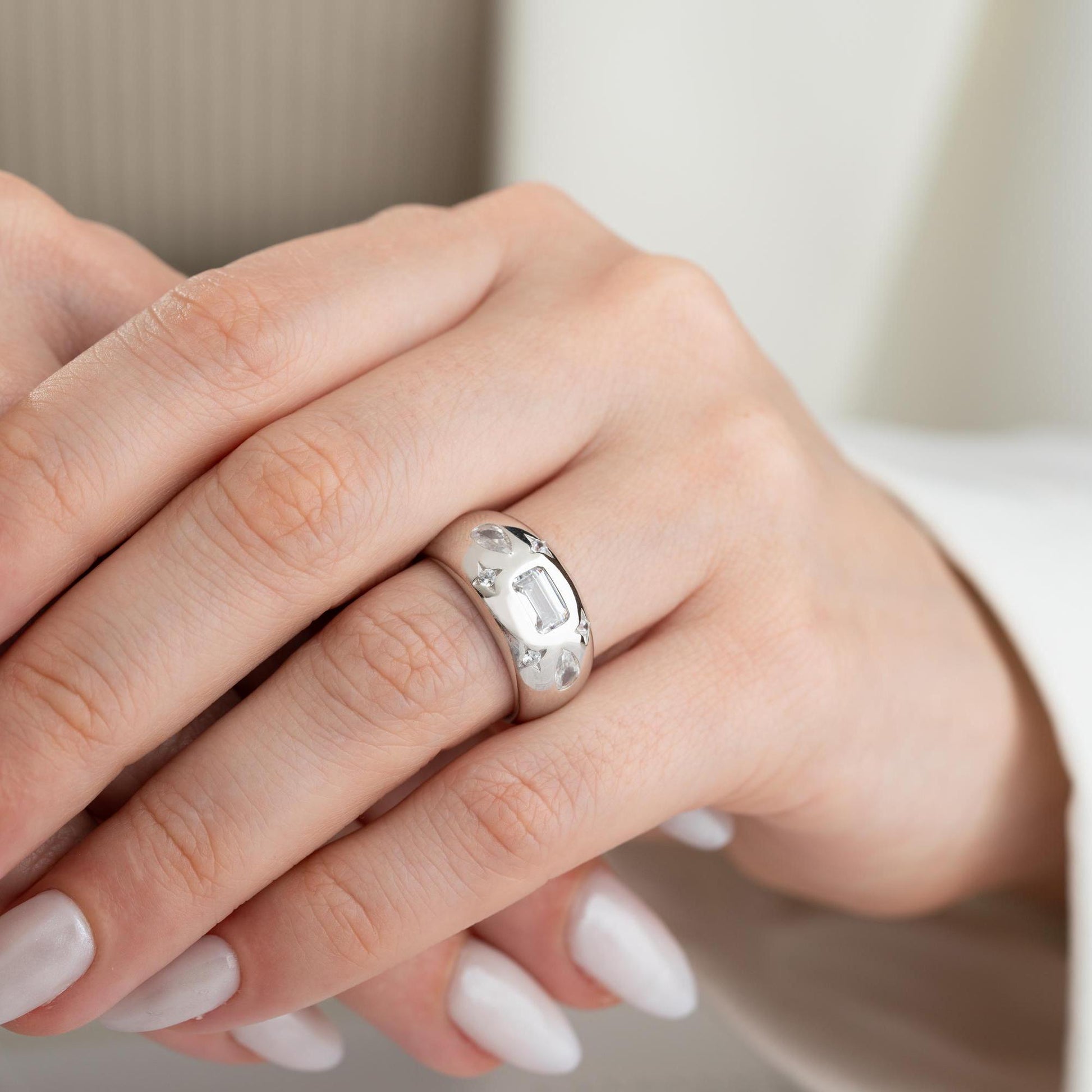 Baguette and teardrop cubic zirconia band ring in 925 sterling silver and 14K gold plating, featuring celestial star motifs. Elegant statement ring for women.