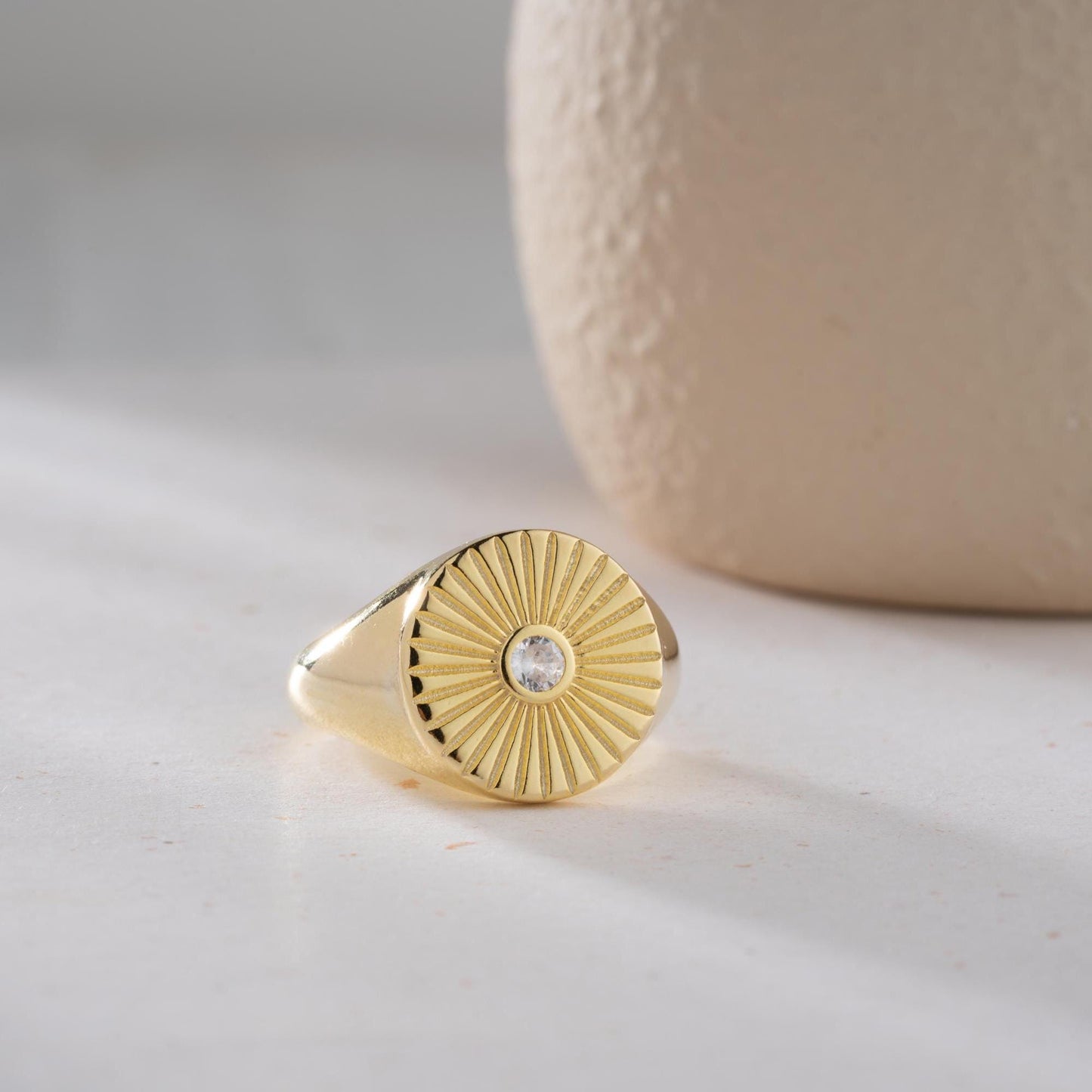 Sunburst engraved statement ring in 925 sterling silver and 14K gold plating with a center cubic zirconia stone.