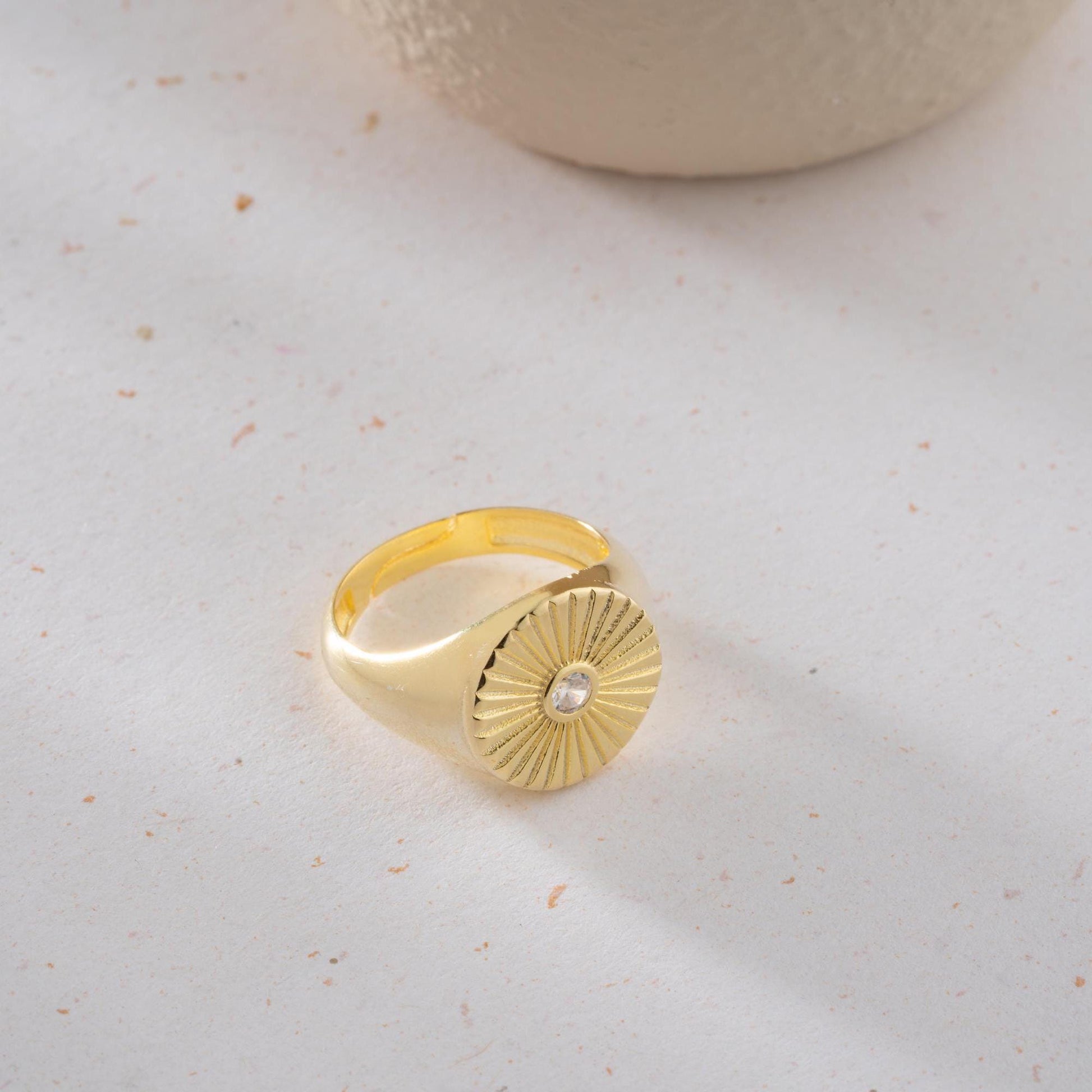 Sunburst engraved statement ring in 925 sterling silver and 14K gold plating with a center cubic zirconia stone.
