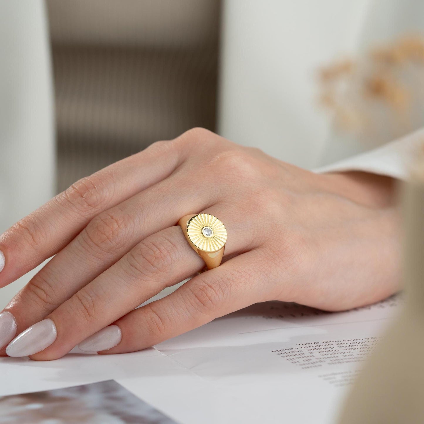 Sunburst engraved statement ring in 925 sterling silver and 14K gold plating with a center cubic zirconia stone.