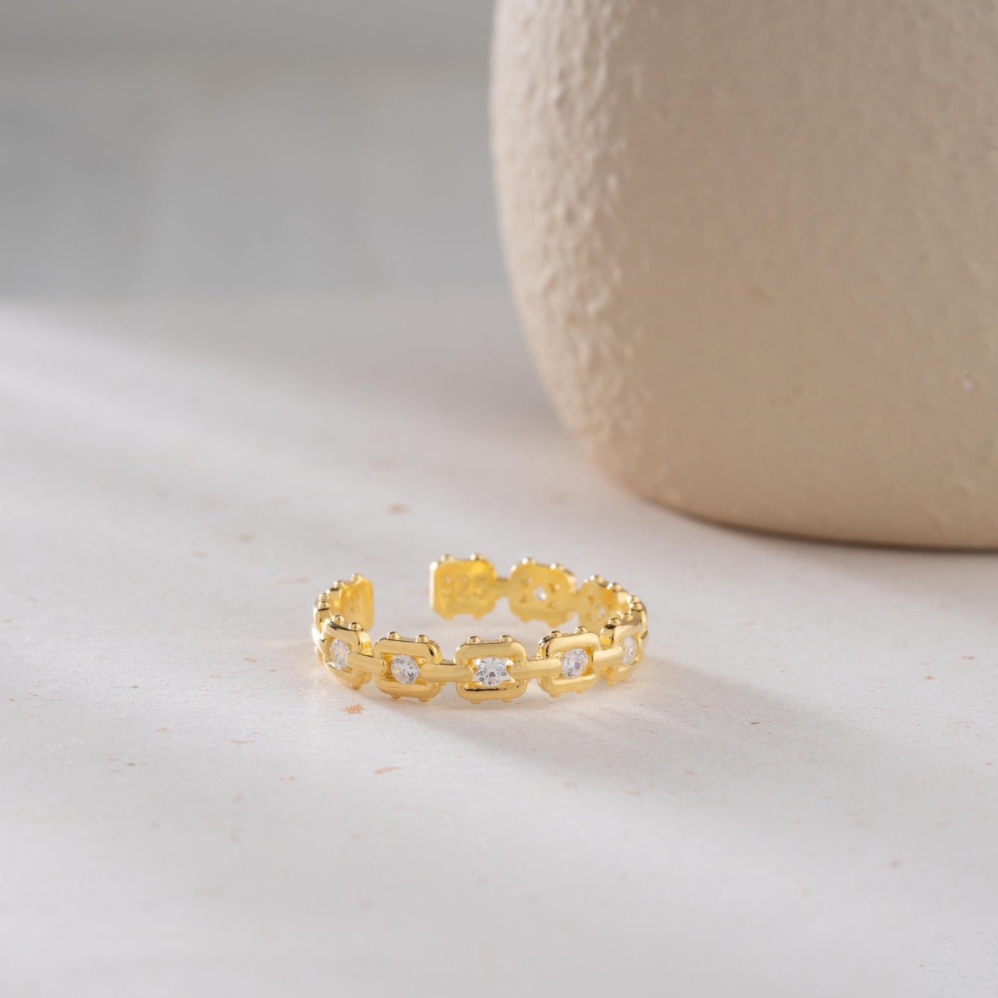 A dazzling chain link eternity ring with cubic zirconia stones, handcrafted from 925 sterling silver and available in silver or 14K gold plated finishes. Ideal for birthdays, anniversaries, and gifts for her.
