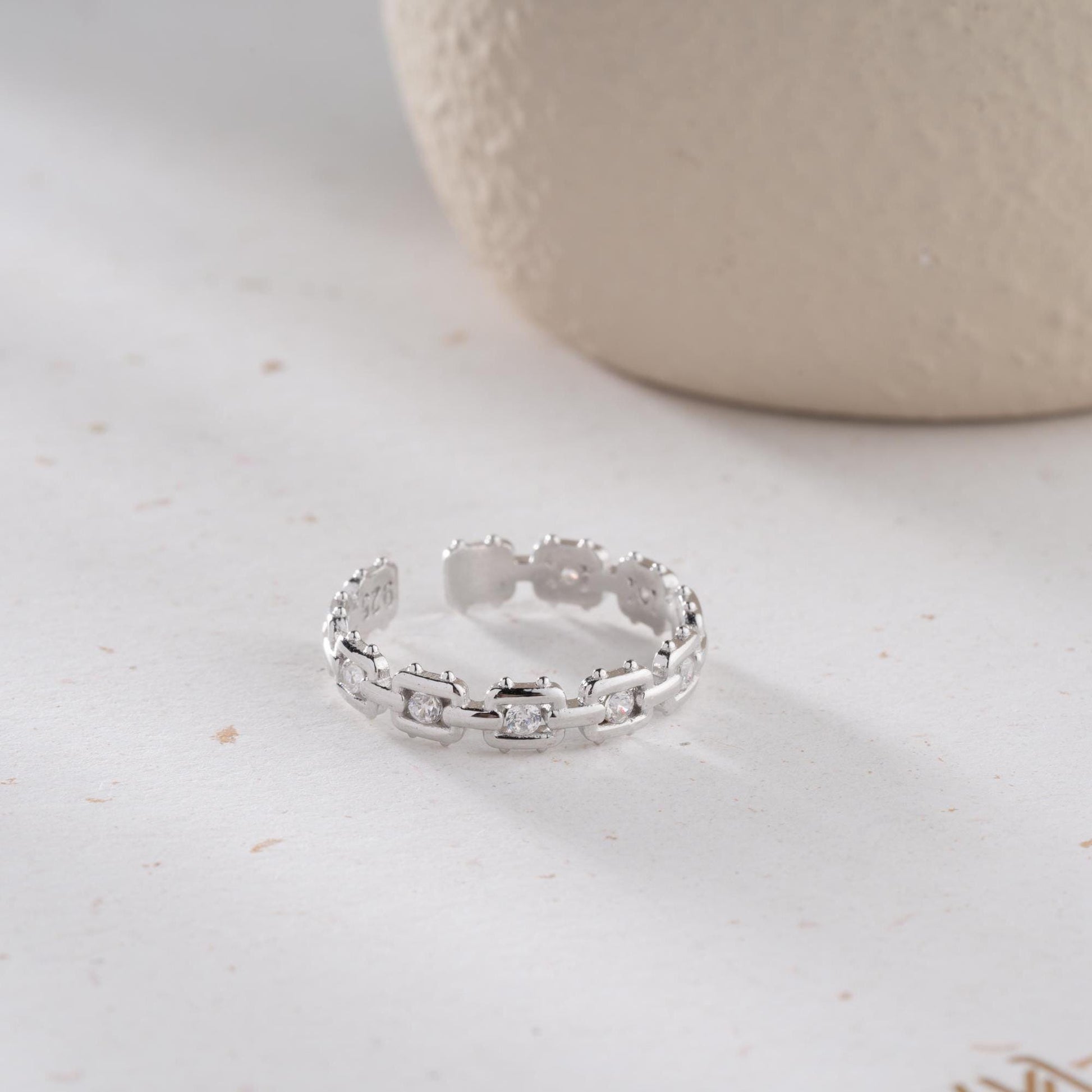 A dazzling chain link eternity ring with cubic zirconia stones, handcrafted from 925 sterling silver and available in silver or 14K gold plated finishes. Ideal for birthdays, anniversaries, and gifts for her.