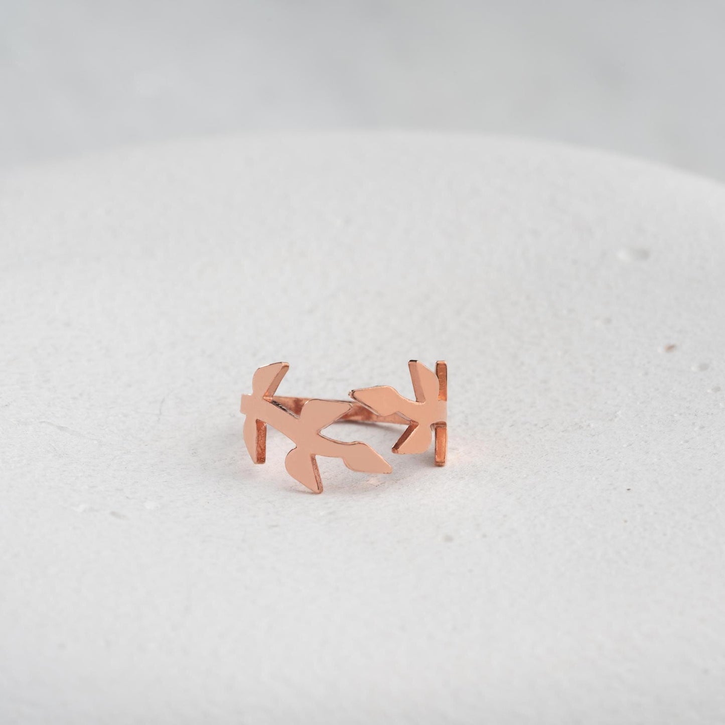 A delicate olive branch-inspired ring crafted from 925 Sterling Silver, available in gold and rose gold plating. Adjustable open band, perfect for nature lovers and elegant gifting.