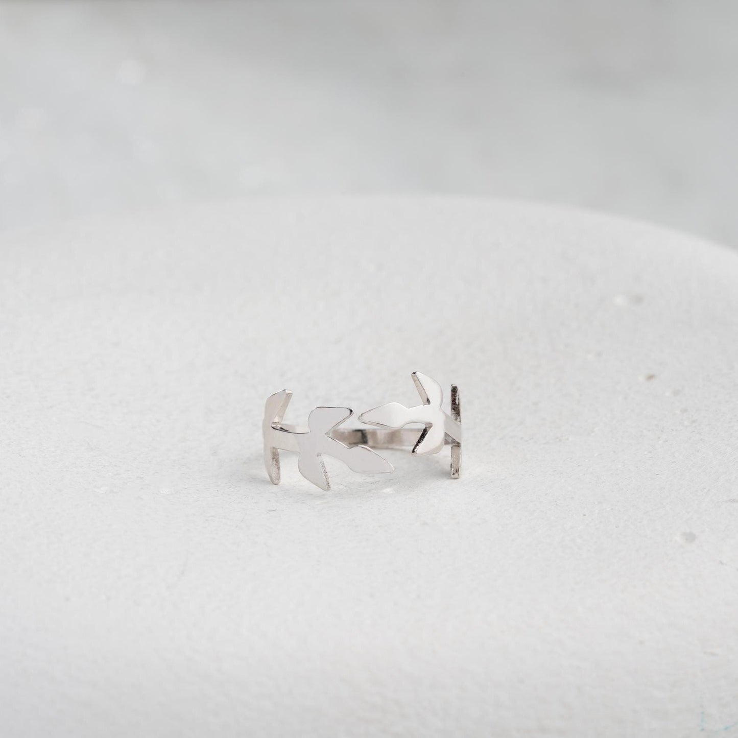 A delicate olive branch-inspired ring crafted from 925 Sterling Silver, available in gold and rose gold plating. Adjustable open band, perfect for nature lovers and elegant gifting.