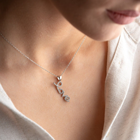 Handmade sterling silver; necklace with shimmering zircon stones delicately set along the word, reflecting elegance and romance